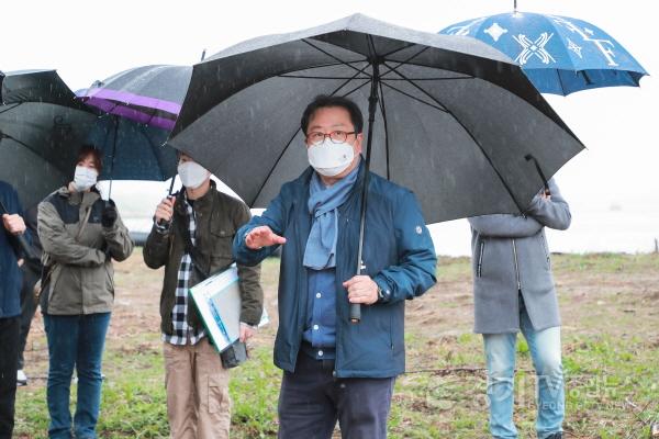 [크기변환]비가 오는 날씨에도 관계공무원들과 삼패 한강변 정비사업에 대해 논의하고 있다.JPG